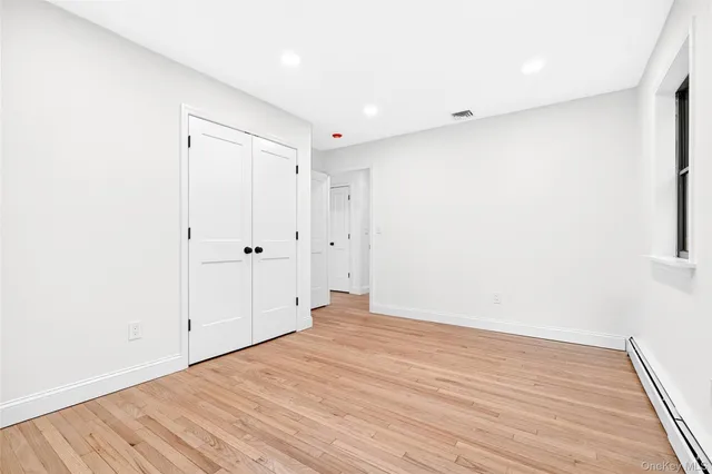 a view of room with wooden floor
