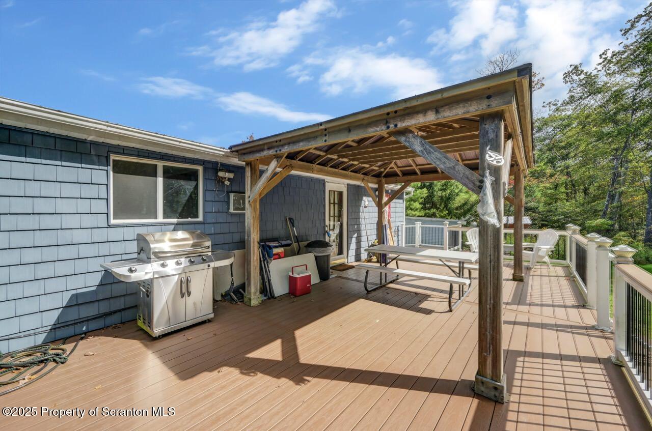 50 Little Lake Road Lake Ariel, PA 18436 - Photo 53 of 73 a view of a patio with table and chairs a barbeque with wooden floor and fence