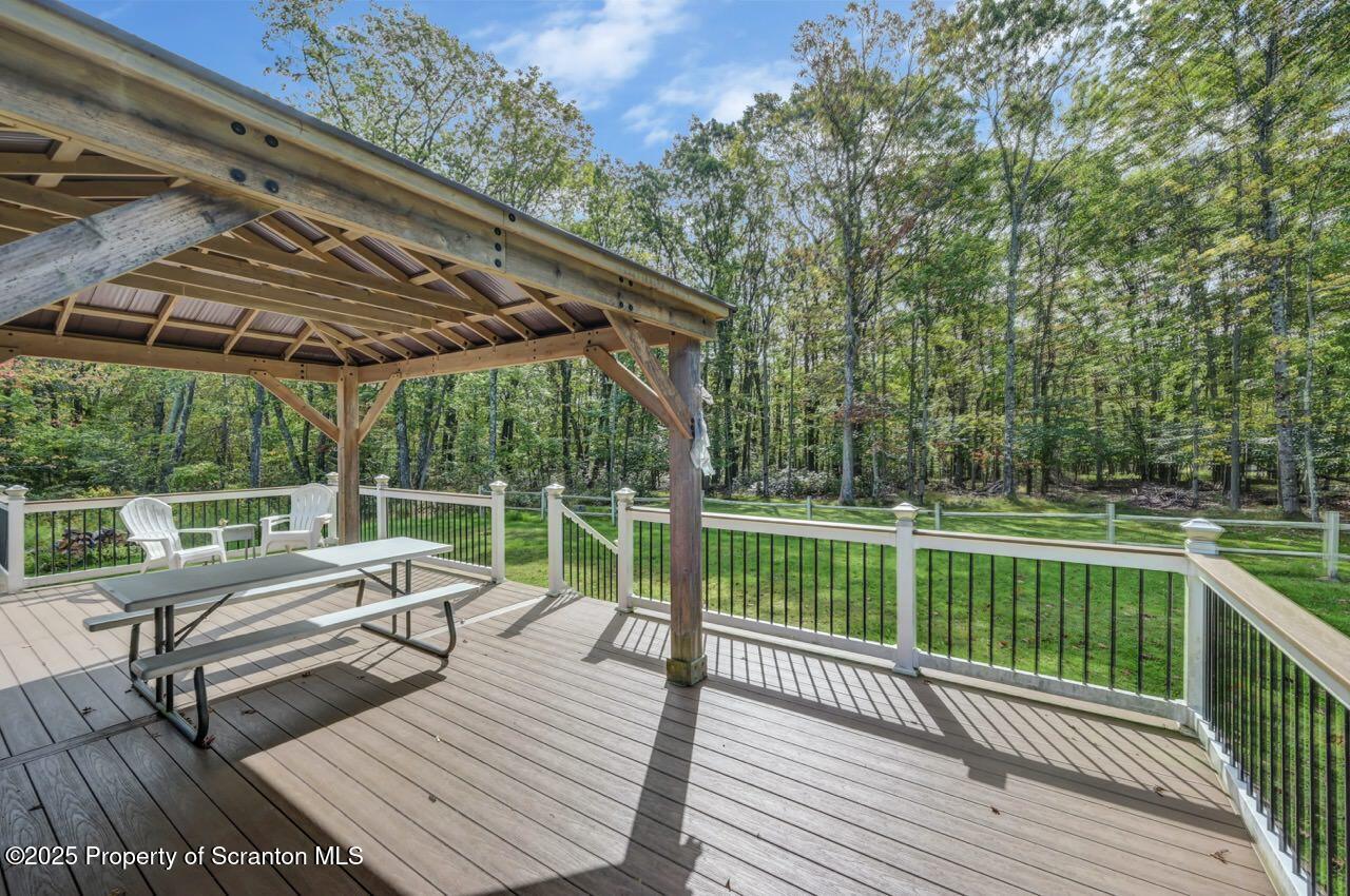 50 Little Lake Road Lake Ariel, PA 18436 - Photo 54 of 73 a view of a wooden deck with chairs and large trees