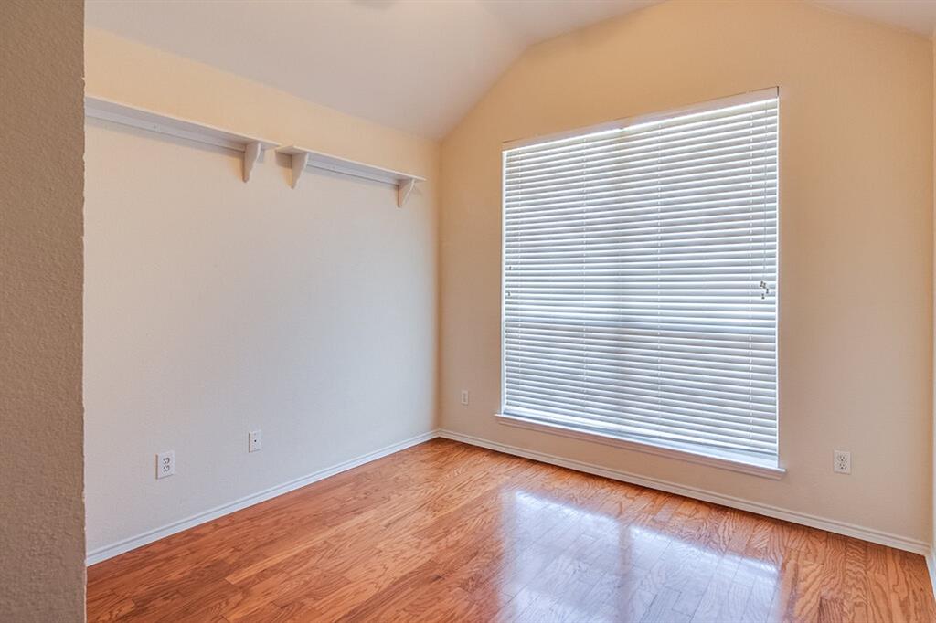 1304 Meredith Drive Allen, TX 75002 - Photo 14 of 28 a view of an empty room with wooden floor and a window
