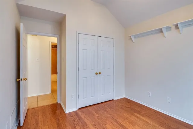 a view of hallway with wooden floor