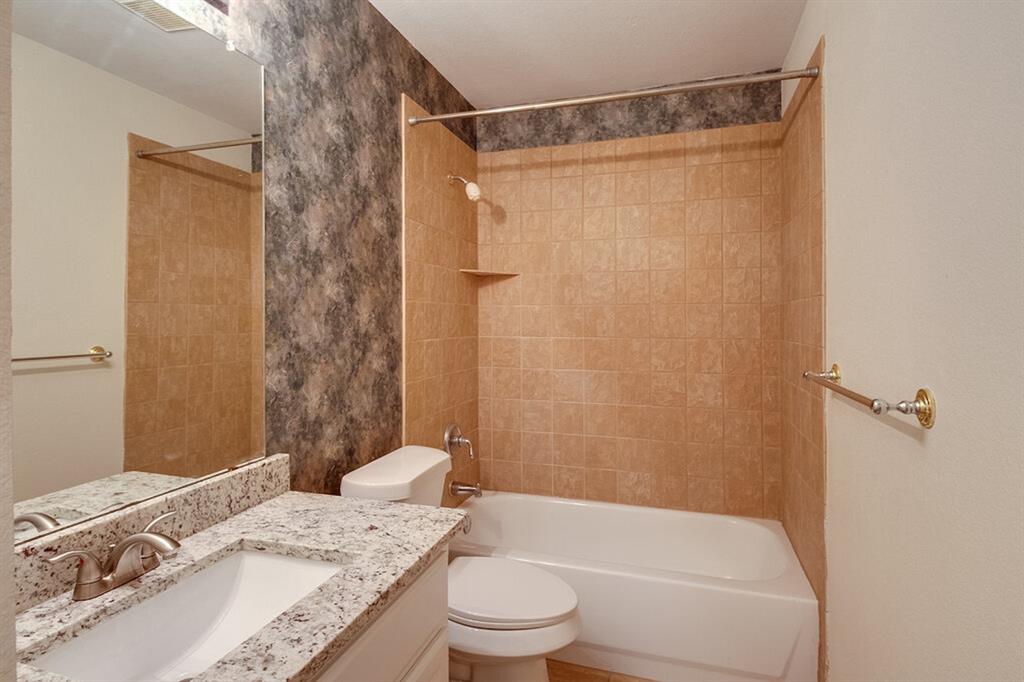 1304 Meredith Drive Allen, TX 75002 - Photo 16 of 28 a bathroom with a granite countertop sink toilet and shower