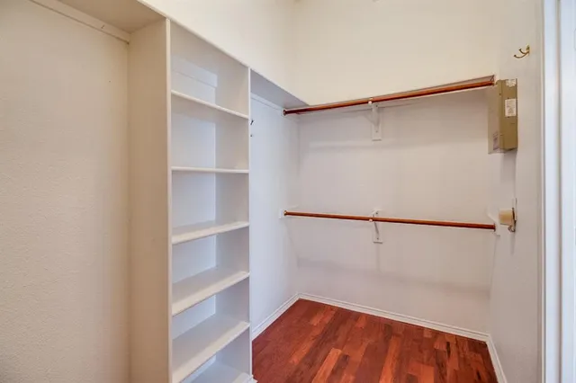 a view of walk in closet with empty racks