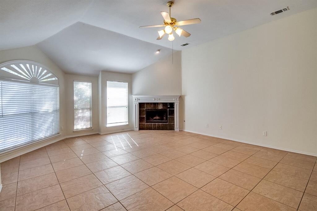 1304 Meredith Drive Allen, TX 75002 - Photo 6 of 28 a view of an empty room with a fireplace and a window