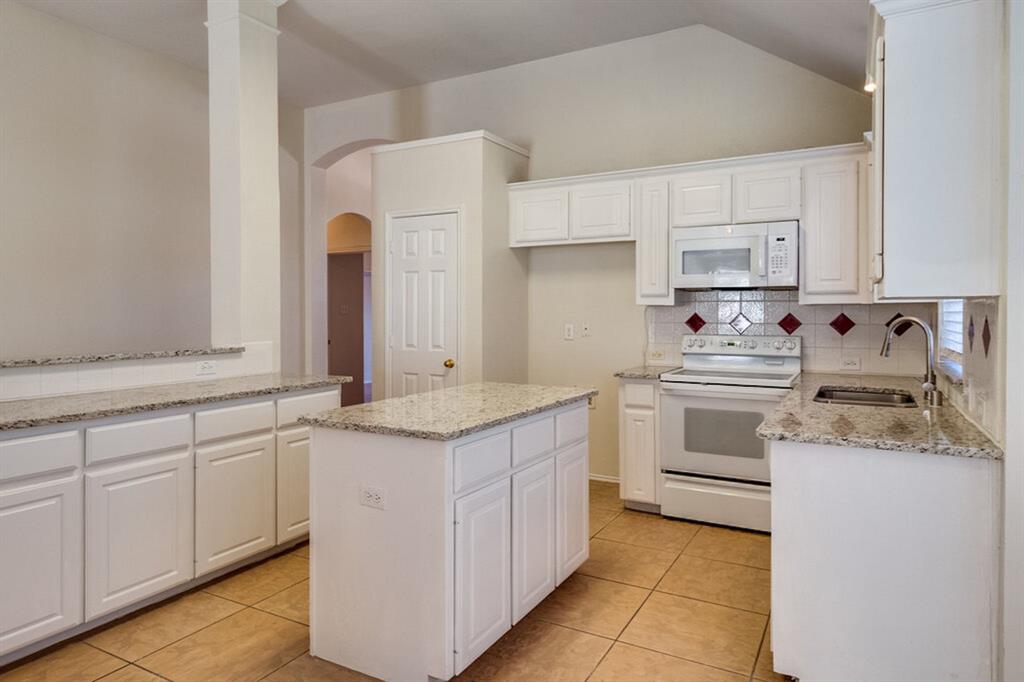 1304 Meredith Drive Allen, TX 75002 - Photo 9 of 28 a kitchen with a sink stove and cabinets