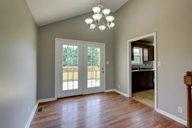 a kitchen with granite countertop cabinets sink and window