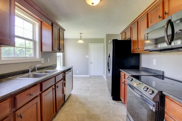 a view of a hallway with wooden floor and closet