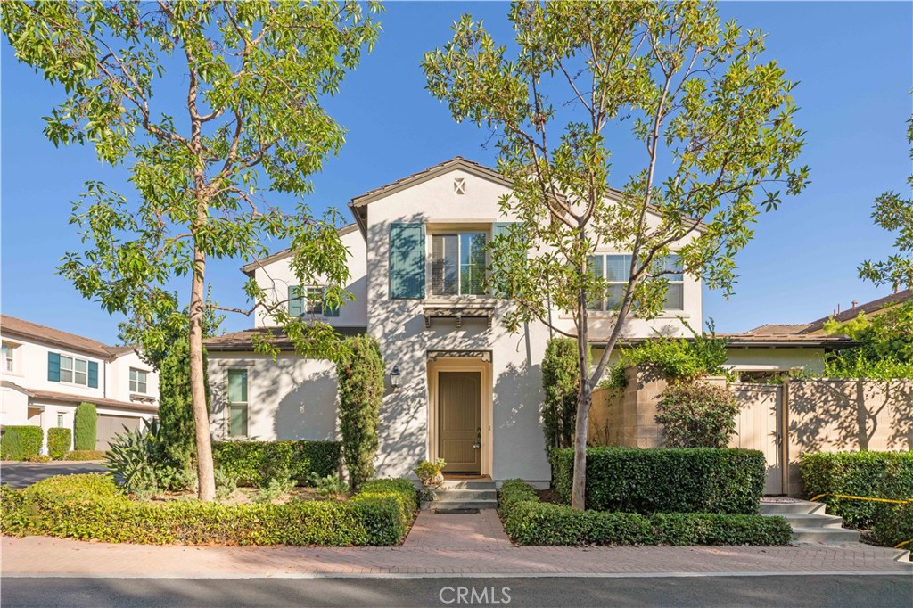 24 Lacebark, Unit 48 Irvine, CA 92618 - Photo 1 of 21 a front view of a house with a yard and garage