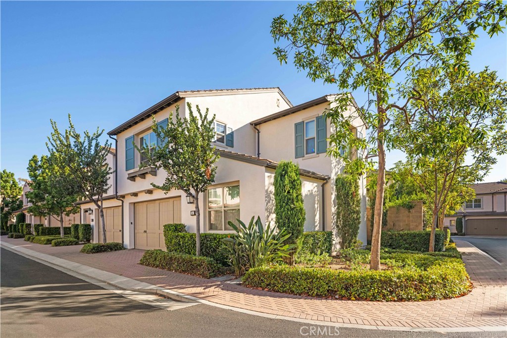 24 Lacebark, Unit 48 Irvine, CA 92618 - Photo 2 of 21 a front view of a house with garden