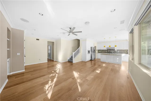 a view of a kitchen with a sink and a large window