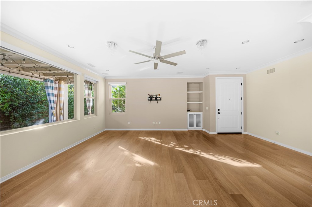 24 Lacebark, Unit 48 Irvine, CA 92618 - Photo 7 of 21 an empty room with windows and ceiling fan
