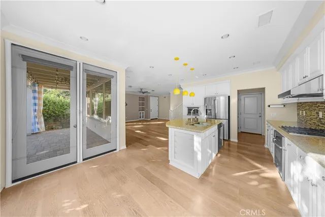 a large kitchen with stainless steel appliances granite countertop a lot of counter top space