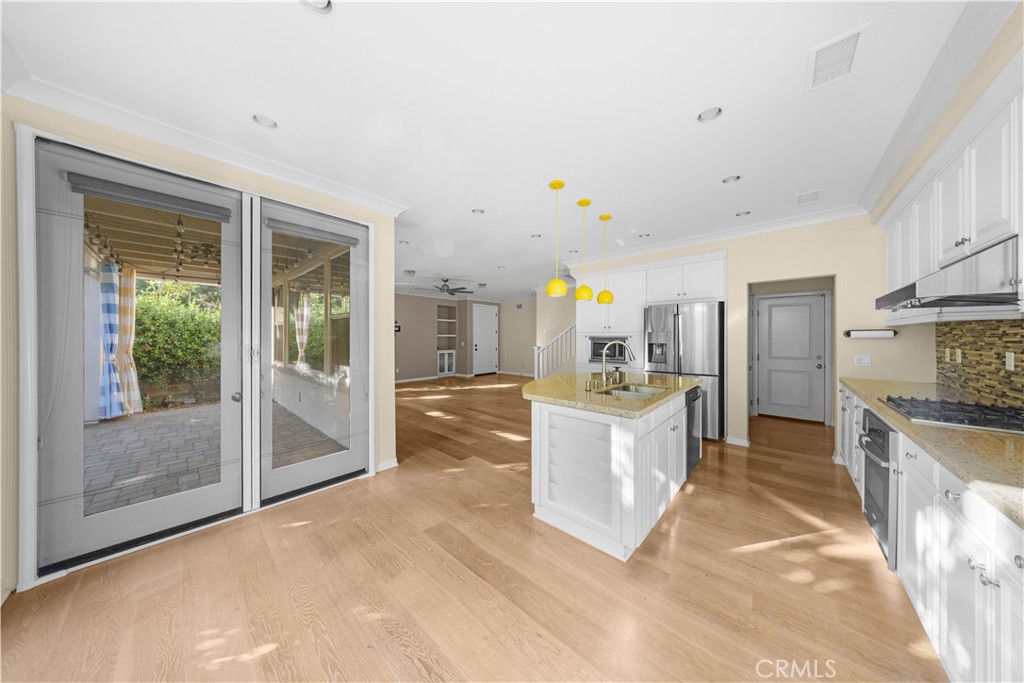 24 Lacebark, Unit 48 Irvine, CA 92618 - Photo 9 of 21 a large kitchen with stainless steel appliances granite countertop a lot of counter top space