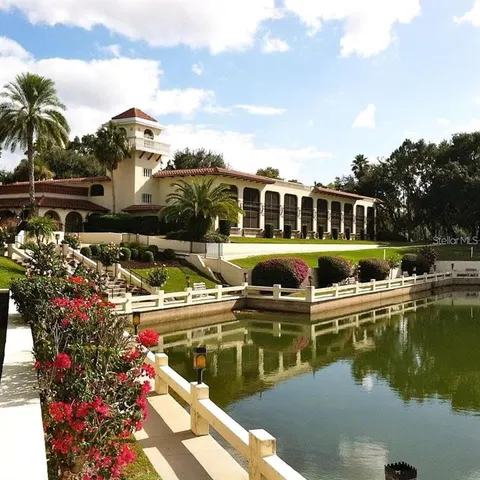 a view of a house with swimming pool and porch with furniture