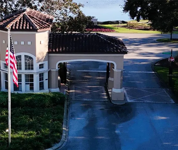 an aerial view of a residential apartment building with a yard and parking spaces