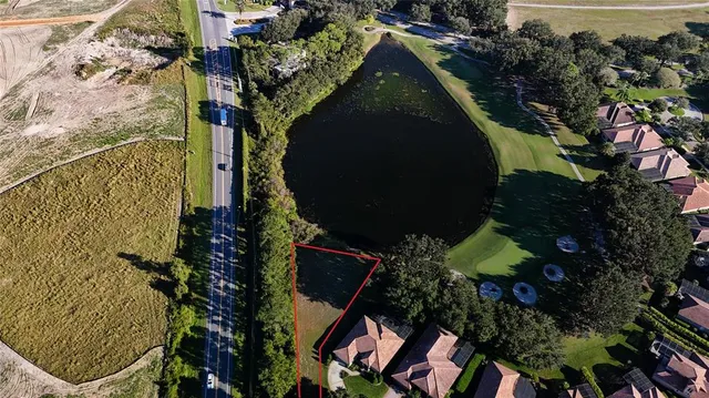 a view of a swimming pool with a patio and a yard