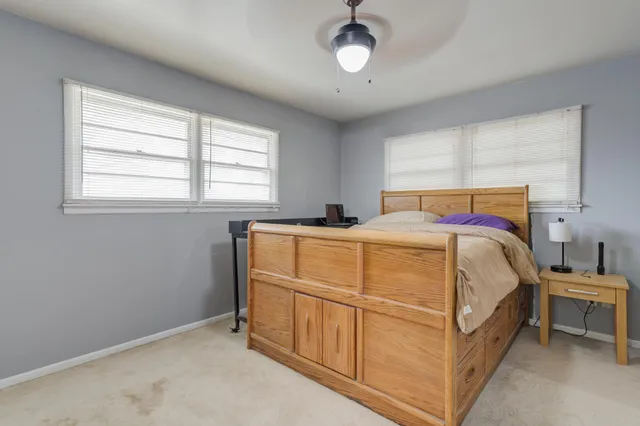 a bedroom with bed and window