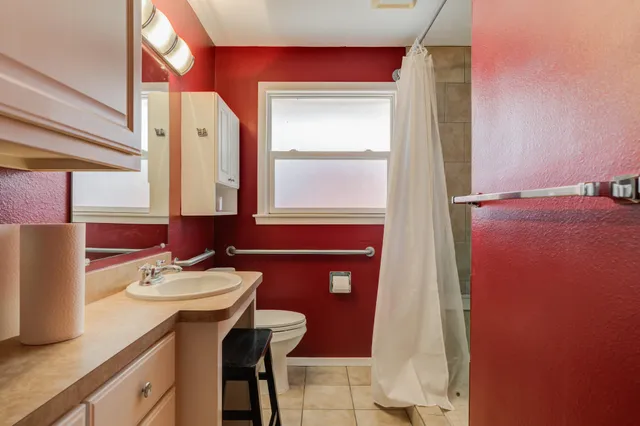 a bathroom with a sink vanity and a mirror