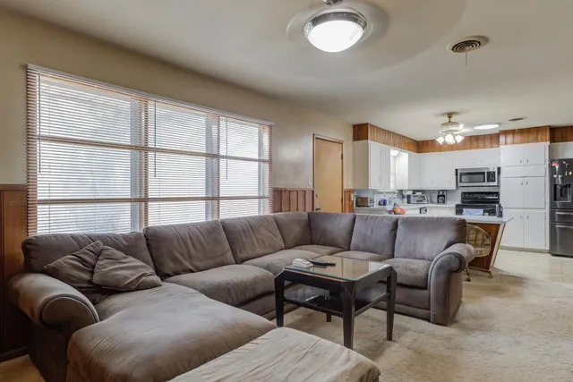 a living room with furniture and a large window