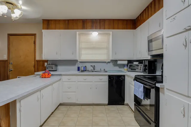 a kitchen with a sink cabinets and appliances