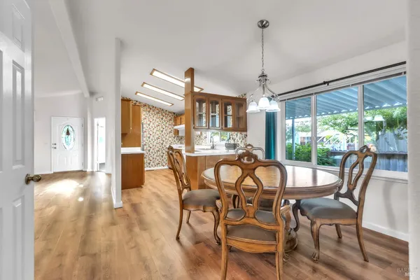 a large kitchen with stainless steel appliances kitchen island granite countertop a sink and cabinets