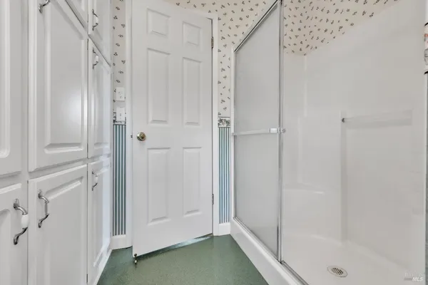 a en suite bathroom with a sink mirror and window