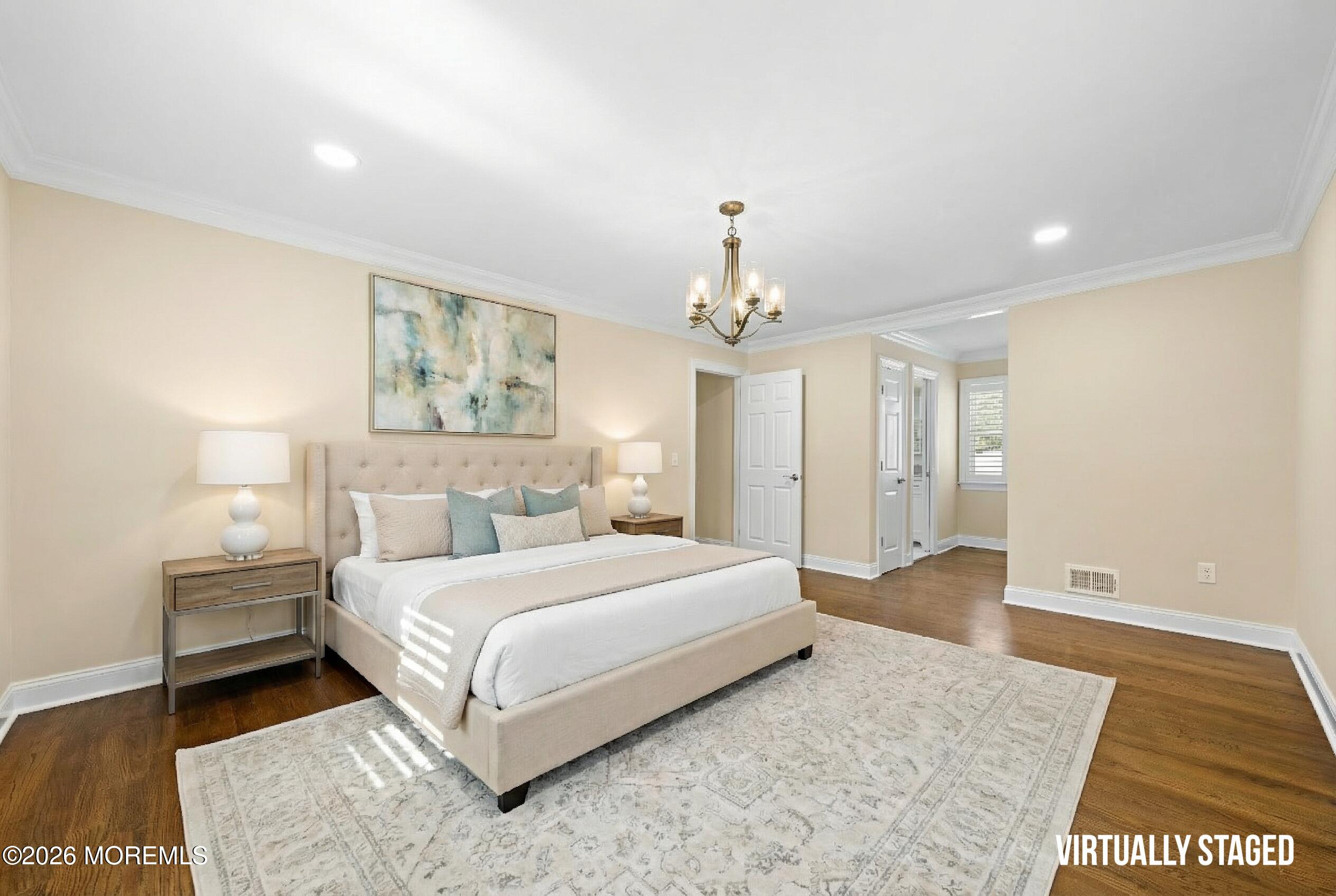 49 Stork Court Middletown, NJ 07748 - Photo 22 of 49 a spacious bedroom with a bed and a chandelier