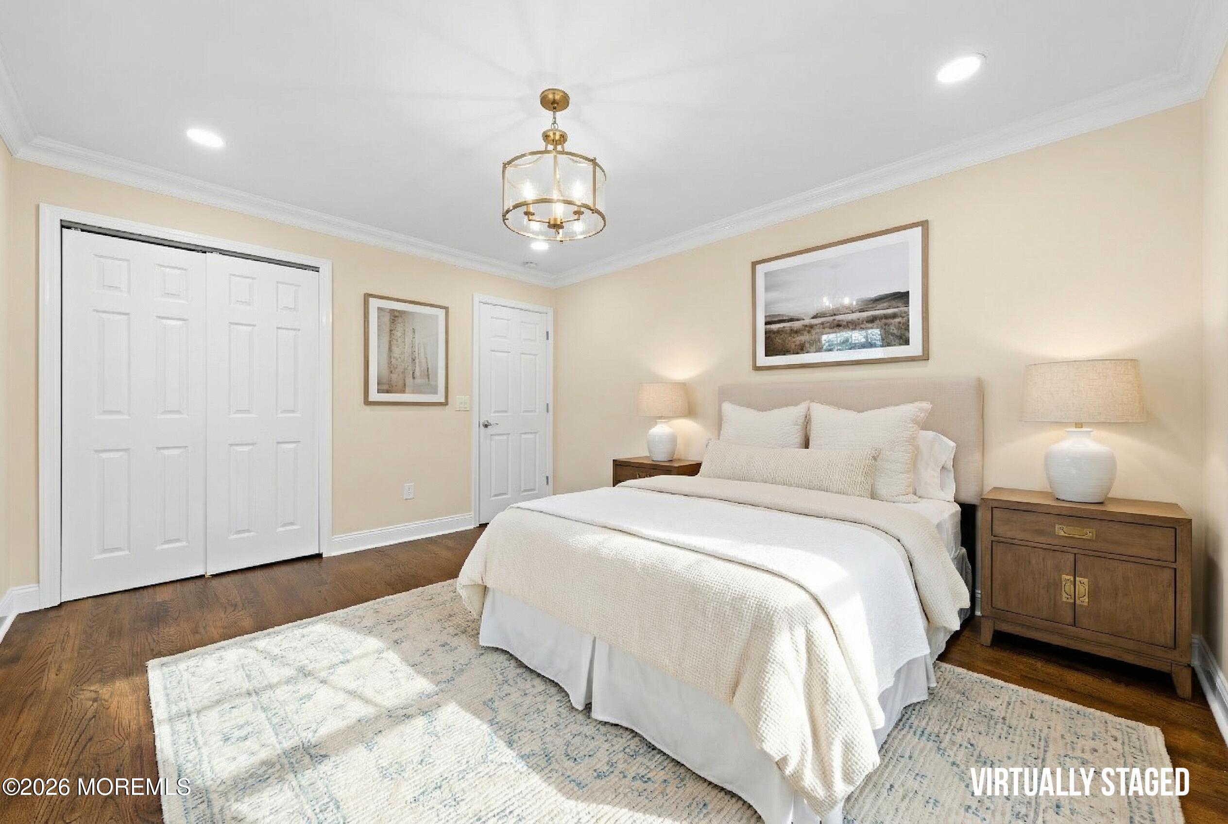 49 Stork Court Middletown, NJ 07748 - Photo 27 of 49 a bedroom with a large bed and a chandelier