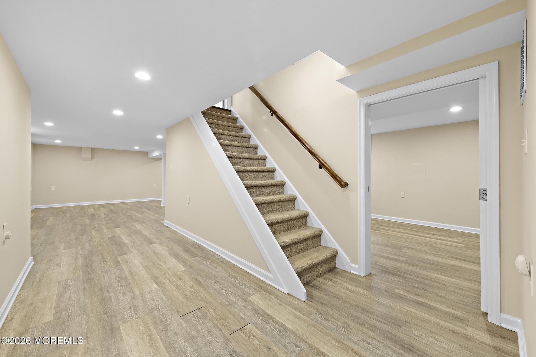49 Stork Court Middletown, NJ 07748 - Photo 34 of 49 a view of a hallway with wooden floor and staircase
