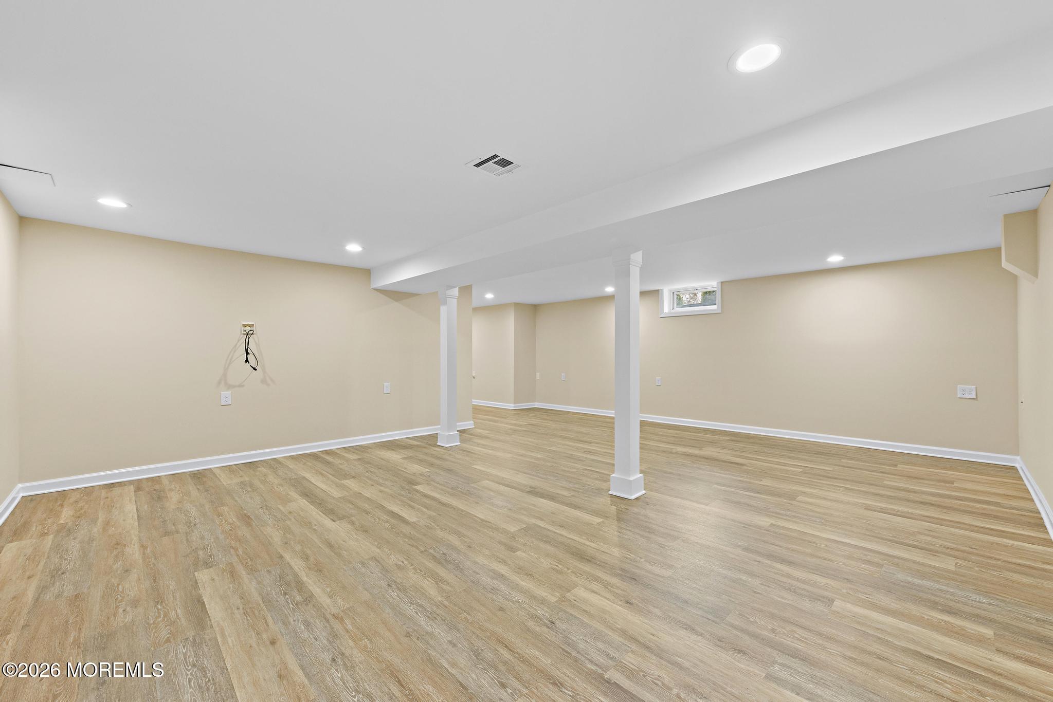 49 Stork Court Middletown, NJ 07748 - Photo 36 of 49 an empty room with wooden floor and windows
