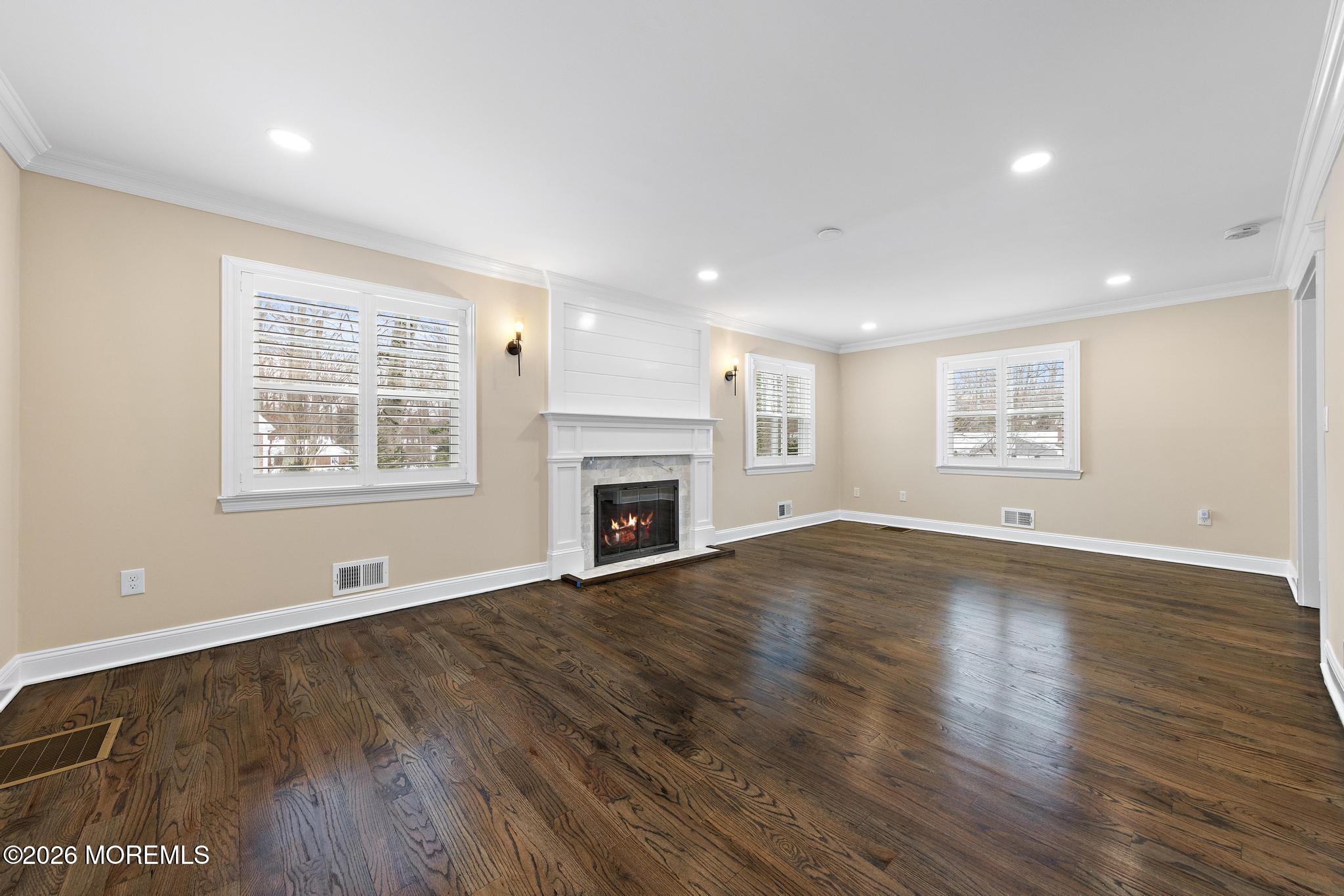 49 Stork Court Middletown, NJ 07748 - Photo 8 of 49 an empty room with wooden floor and windows
