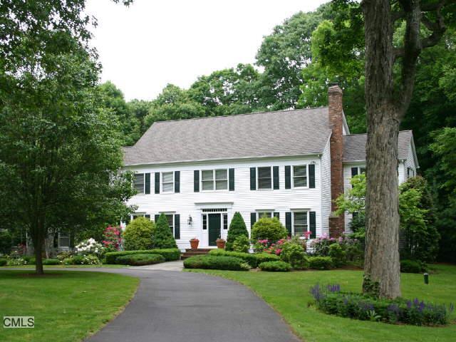 20 Aarons Court Ridgefield, CT 06877 - Photo 1 of 1 a view of a white house with a big yard and potted plants and large trees