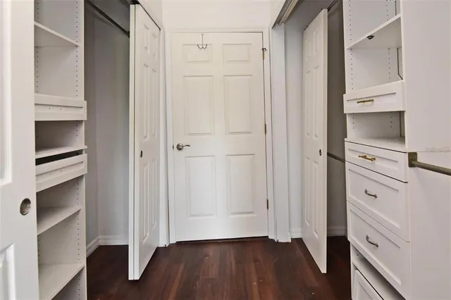 a view of walk in closet with empty racks