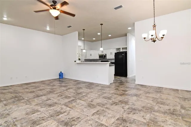 a view of a kitchen with a sink and chandelier