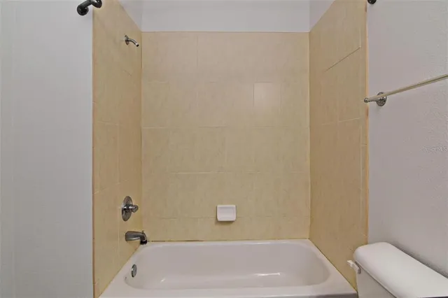 a bathroom with a tub and toilet