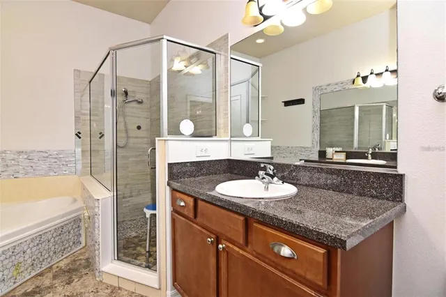 a bathroom with a granite countertop sink and a mirror