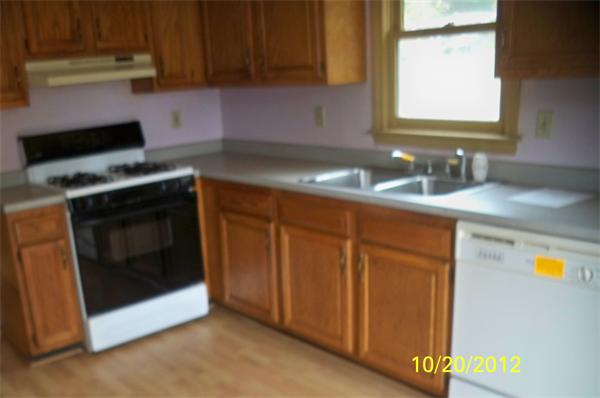 64 Mission Road Tyngsborough, MA 01879 - Photo 2 of 7 a kitchen with granite countertop cabinets stainless steel appliances and a counter space