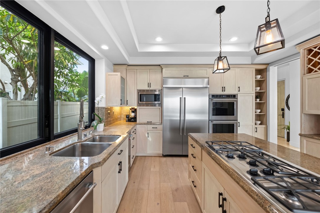 5381 Moonlight Lane La Jolla, CA 92037 - Photo 11 of 44 a kitchen with stainless steel appliances granite countertop a sink a stove and a refrigerator