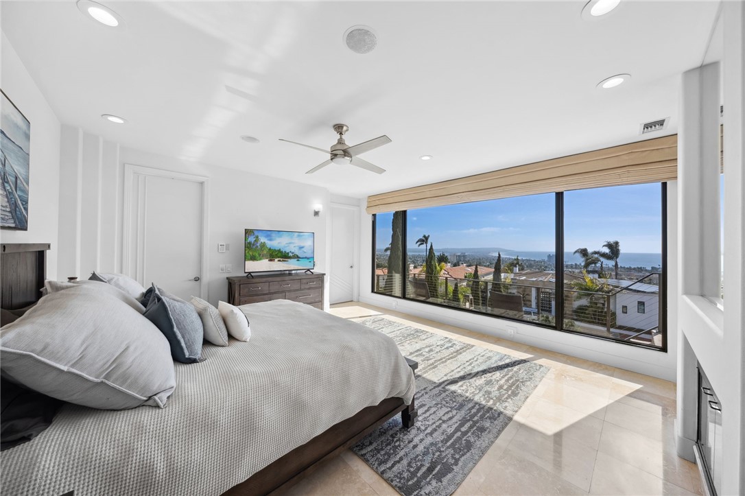 5381 Moonlight Lane La Jolla, CA 92037 - Photo 32 of 44 a bedroom with a large bed and a large window