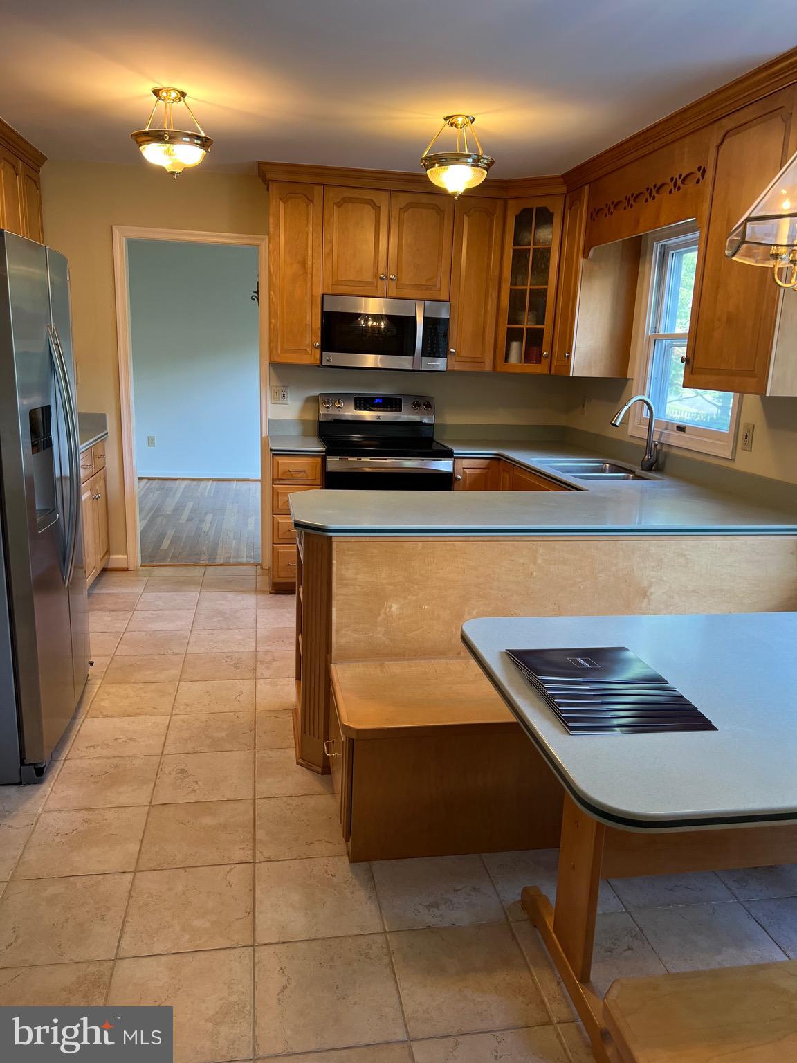 204 Pewter Lane Silver Spring, MD 20905 - Photo 3 of 12 a kitchen with stainless steel appliances a stove a sink and a microwave