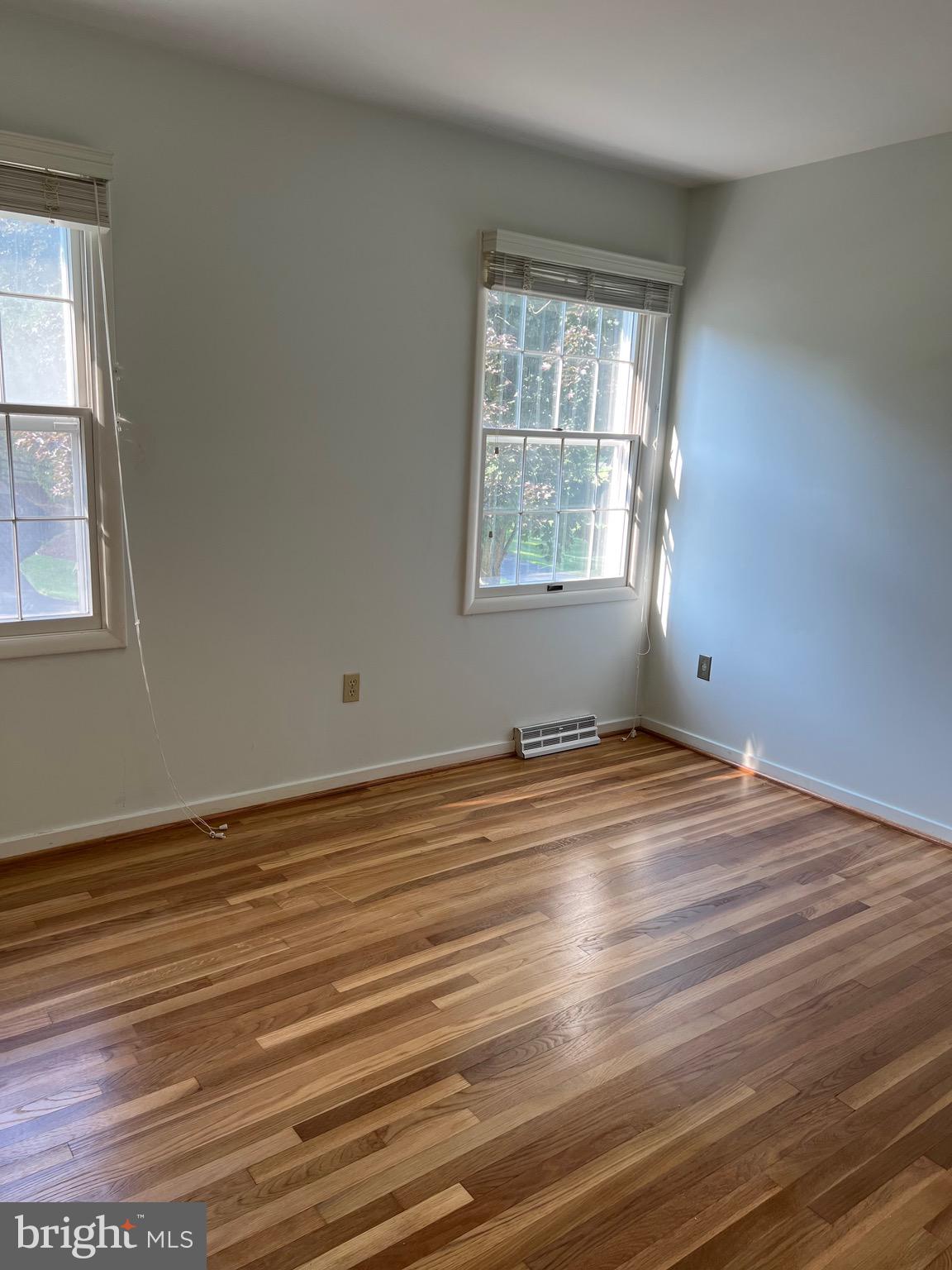 204 Pewter Lane Silver Spring, MD 20905 - Photo 6 of 12 a view of empty room with wooden floor and fan