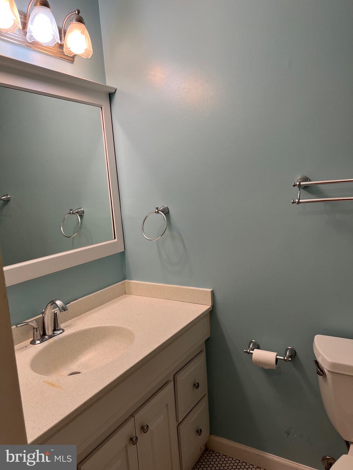 204 Pewter Lane Silver Spring, MD 20905 - Photo 9 of 12 a bathroom with a sink a toilet and mirror