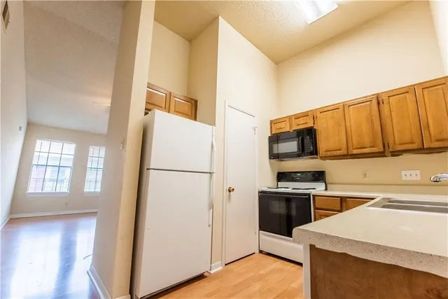 a kitchen with a refrigerator sink and stove top oven