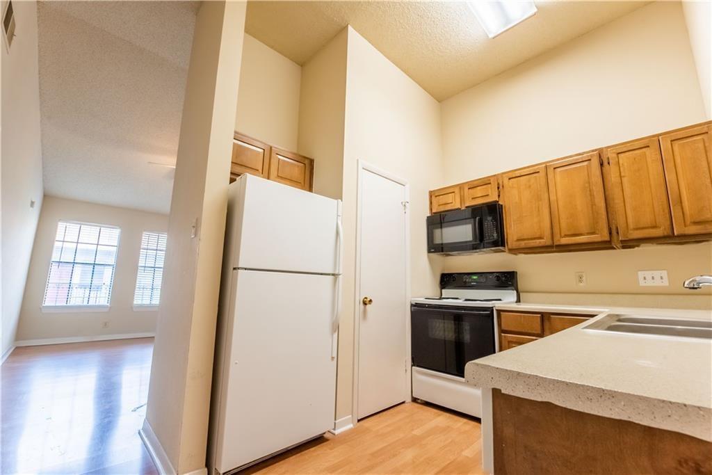 2216 San Gabriel Street, Unit 206 Austin, TX 78705 - Photo 3 of 11 a kitchen with a refrigerator sink and stove top oven