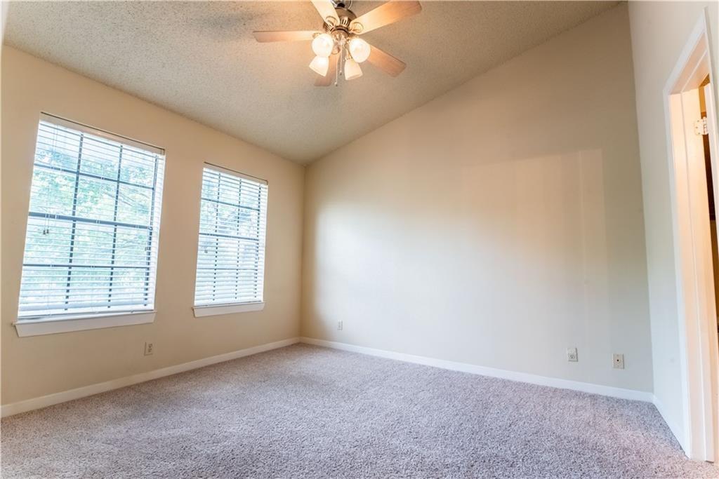 2216 San Gabriel Street, Unit 206 Austin, TX 78705 - Photo 7 of 11 an empty room with chandelier fan and windows