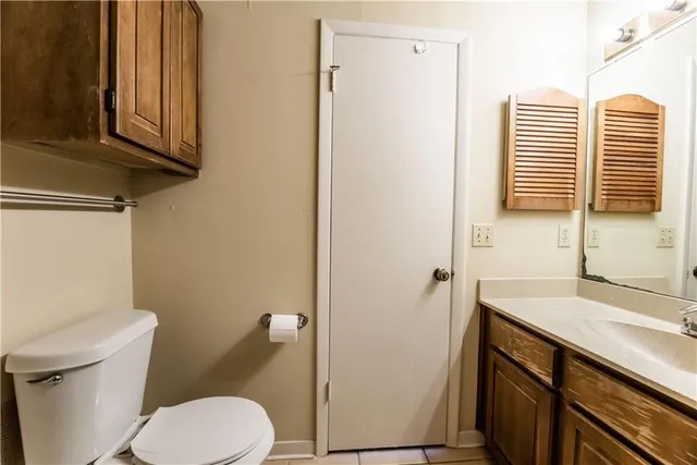 a red brick house with trees in front of it