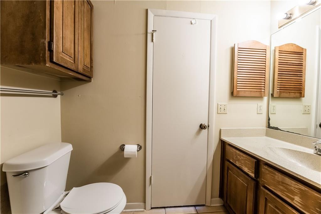 2216 San Gabriel Street, Unit 206 Austin, TX 78705 - Photo 9 of 11 a bathroom with a sink a toilet and vanity