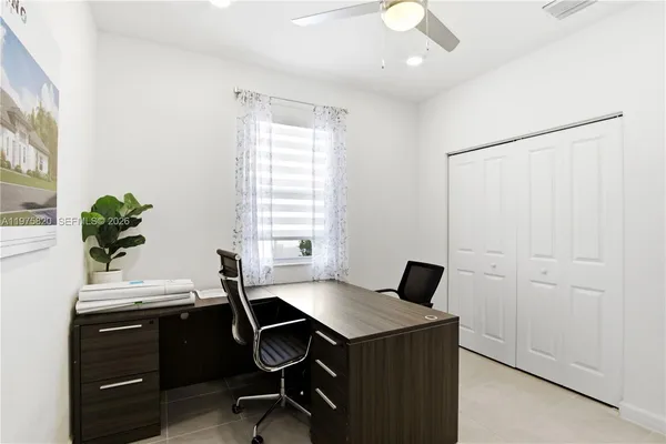 a workspace with furniture and window in it