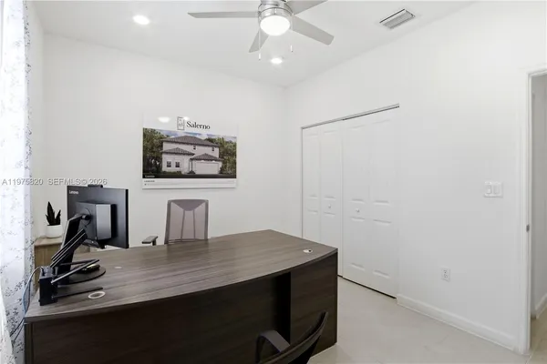 a view of a workspace with furniture