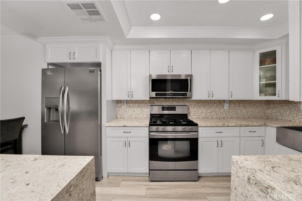 646 Sycamore Avenue, Unit 18 Claremont, CA 91711 - Photo 22 of 46 a kitchen with cabinets stainless steel appliances and sink